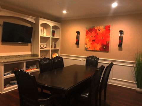 A cozy dining room with elegant furniture and vibrant artwork.