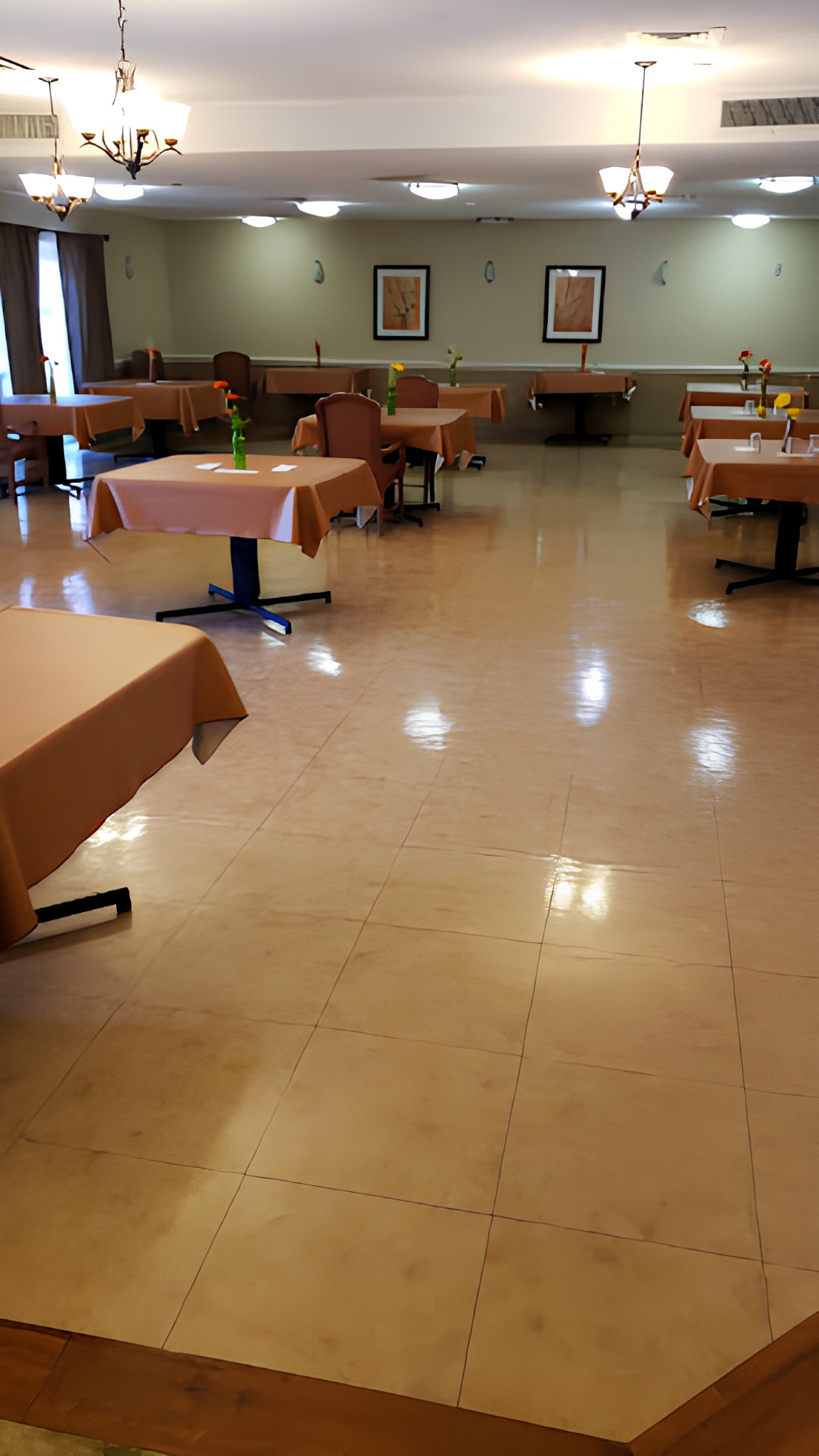 An empty restaurant dining area with arranged tables and chairs.