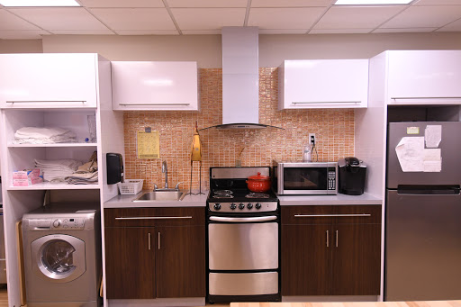 A modern kitchen setup featuring sleek cabinets and essential appliances.