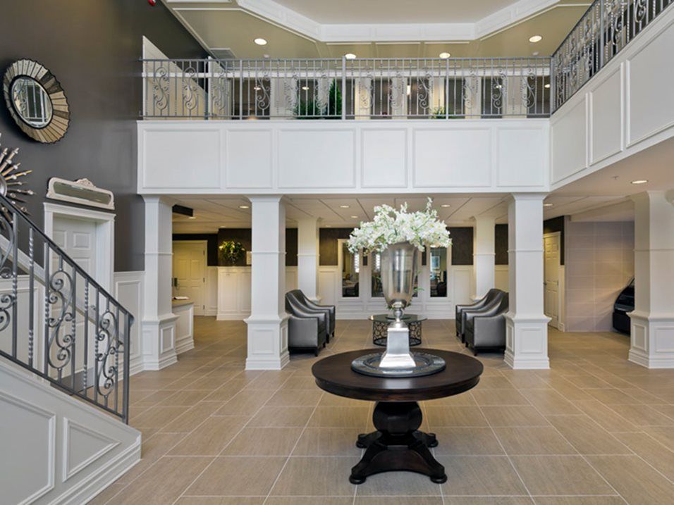 A stylish lobby with a central floral arrangement and elegant furnishings.