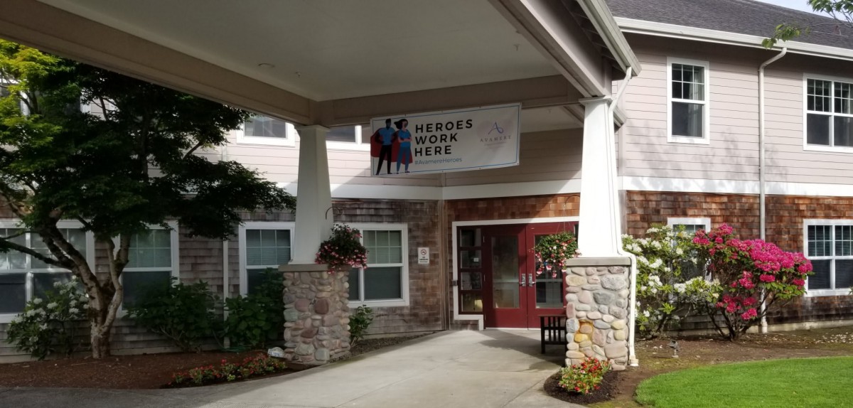 Entrance of a building with a banner reading 'Heroes Work Here'.