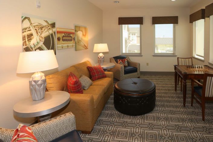 A cozy living room with a sofa, armchair, and coffee table.