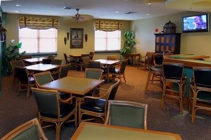 An empty dining room with tables and chairs neatly arranged.