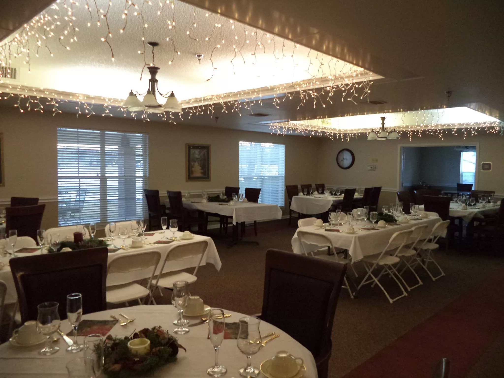 A well-decorated dining area with elegantly arranged tables and chairs, suitable for events.