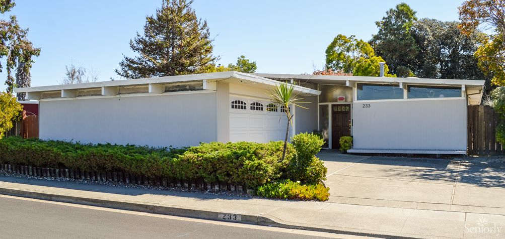 A mid-century modern house with a sleek exterior and well-maintained landscaping.