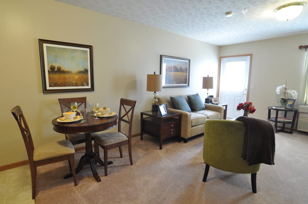A cozy living room with a dining area, featuring comfortable furniture and tasteful decor.