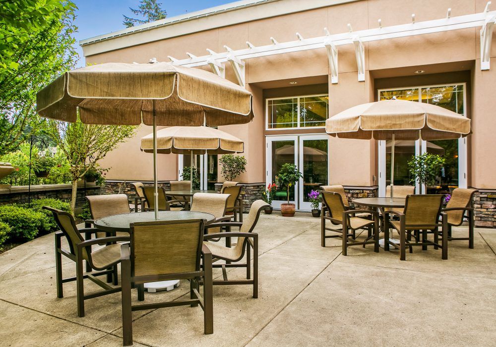 An inviting outdoor patio with several tables and umbrellas, perfect for relaxation.