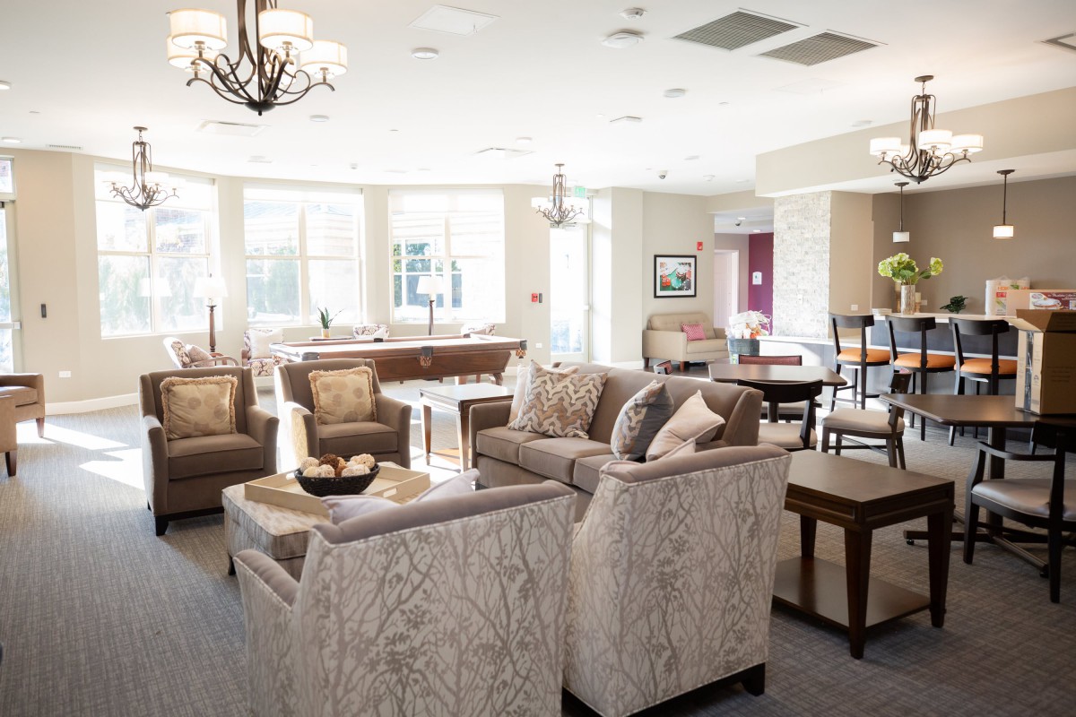 A spacious and well-lit living room with modern furniture and decor.