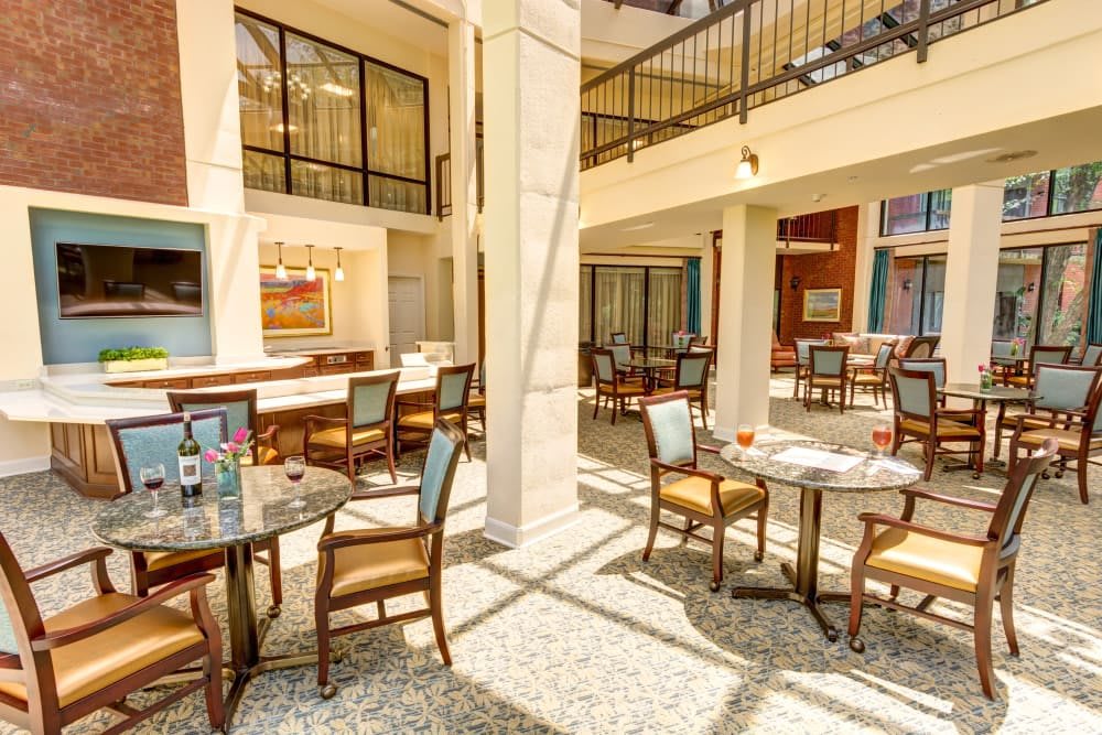 A well-lit restaurant interior with neatly arranged tables and chairs, showcasing a modern and inviting atmosphere.