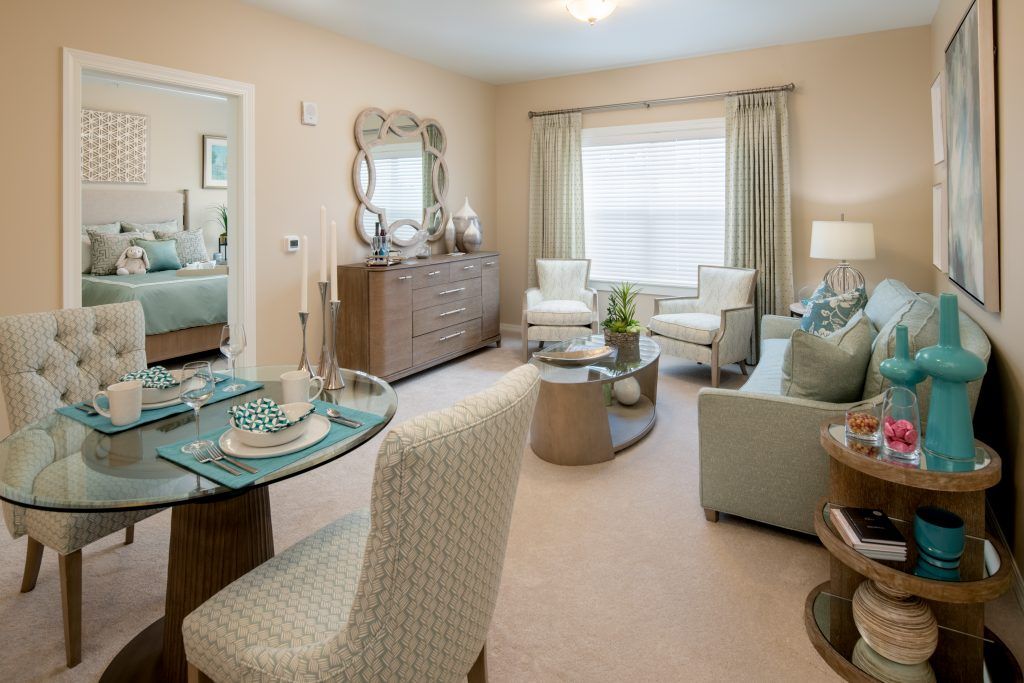 A modern living and dining area featuring neutral tones and contemporary furnishings.