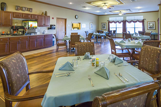 A cozy dining room with neatly set tables and chairs, ready for guests.