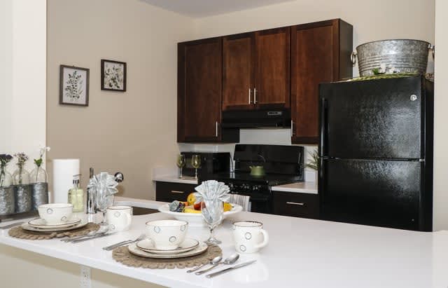 Modern kitchen with dark wood cabinets and a dining setup.