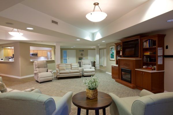 A spacious and modern living room featuring comfortable seating and a fireplace.