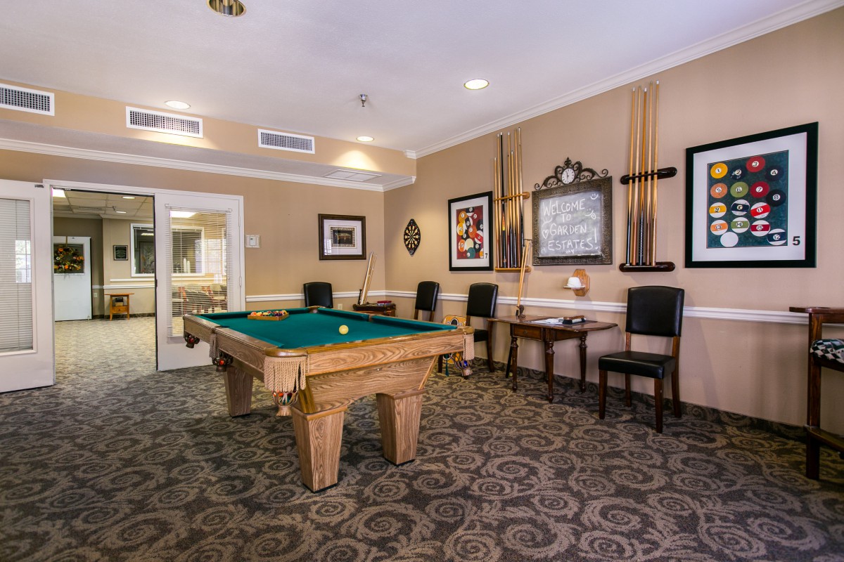 A cozy game room featuring a pool table and comfortable seating.