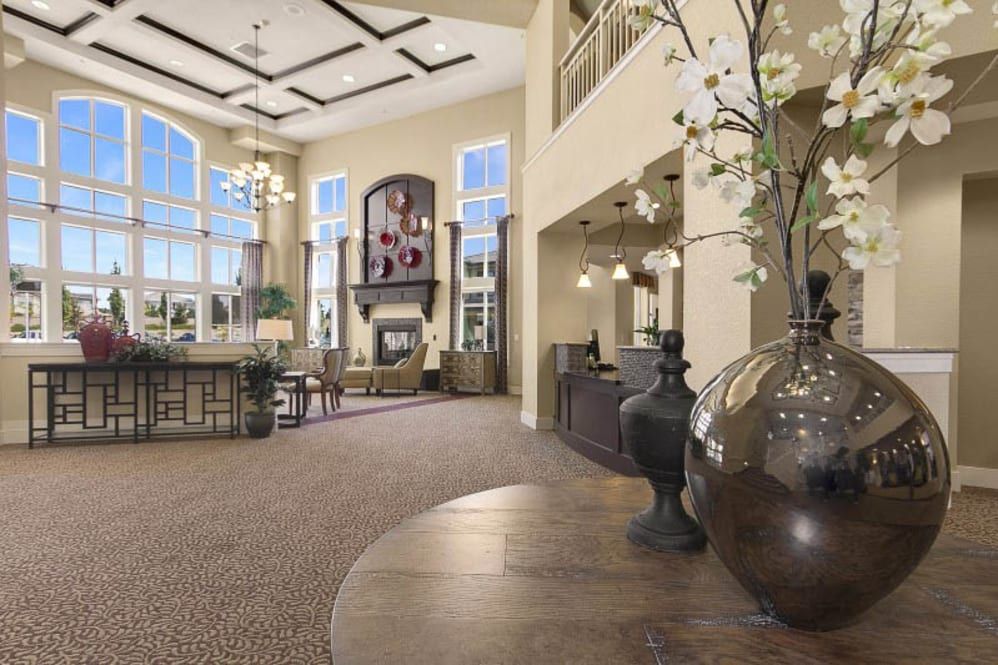 Spacious and elegantly designed lobby with high ceilings, large windows, and decorative elements.