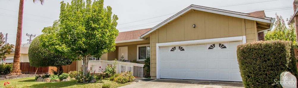A suburban house with a garage and front yard.