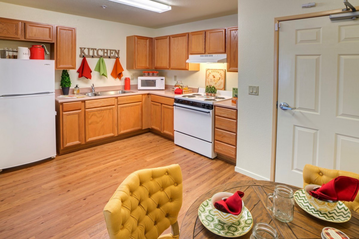 Cozy kitchen with wooden cabinets and a small dining area.
