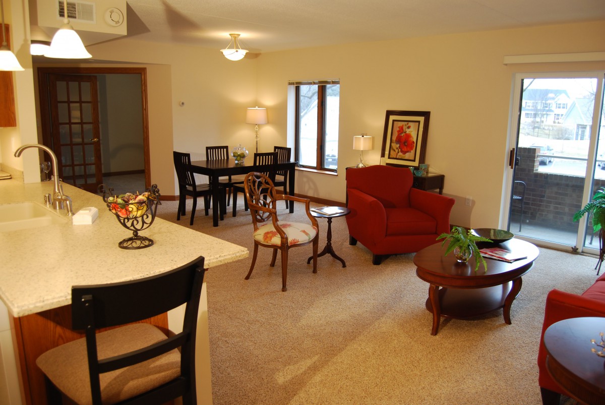 A cozy living room and dining area with comfortable seating and warm lighting.