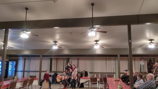 An evening of music and camaraderie as performers entertain the audience in a cozy setting.