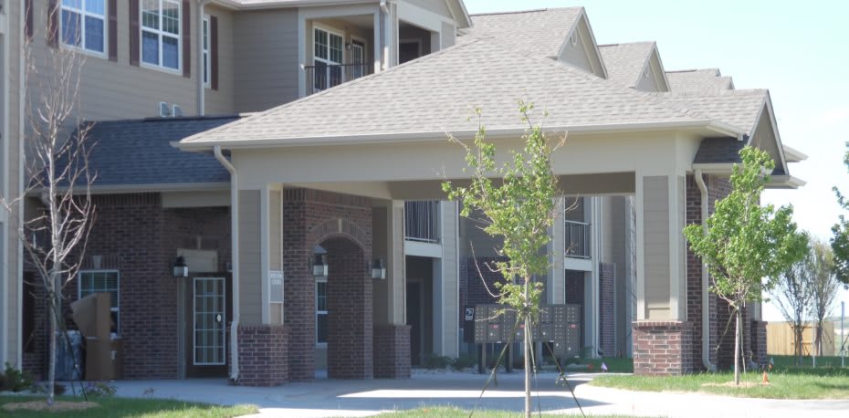 A modern apartment building with a covered entrance.