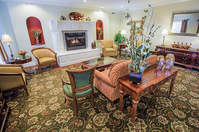 A cozy living room with elegant furniture and a warm fireplace.