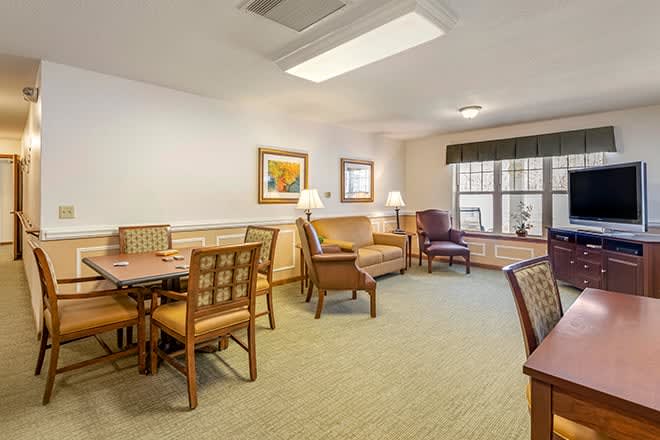 A cozy living room with comfortable seating and a large window.