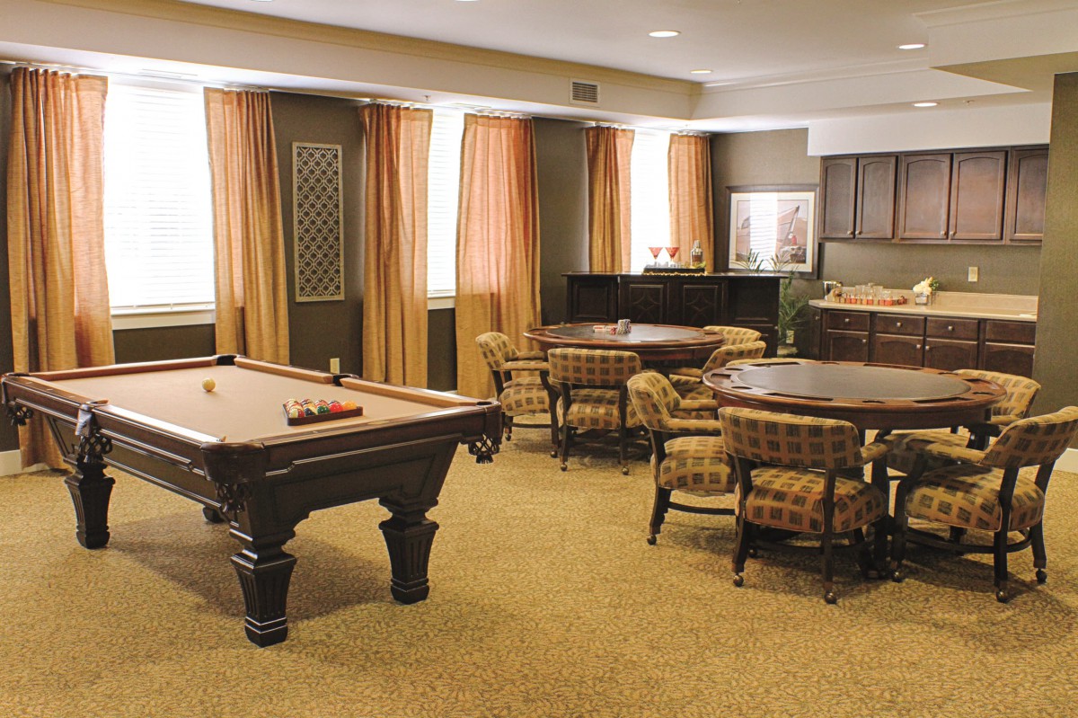 A cozy indoor recreational space featuring a pool table and seating area.