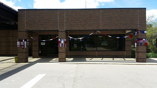 A storefront decorated with banners, showcasing a brick facade under a clear sky.