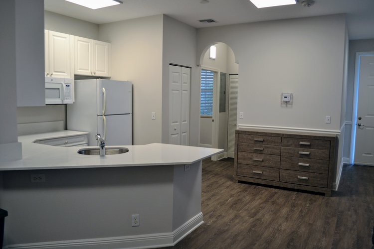 A modern kitchen with white cabinets and a central island.