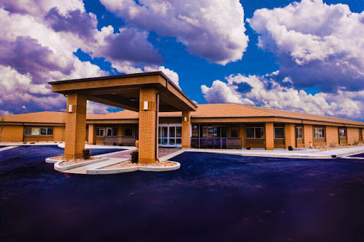 A modern building under a vibrant, cloud-filled sky.