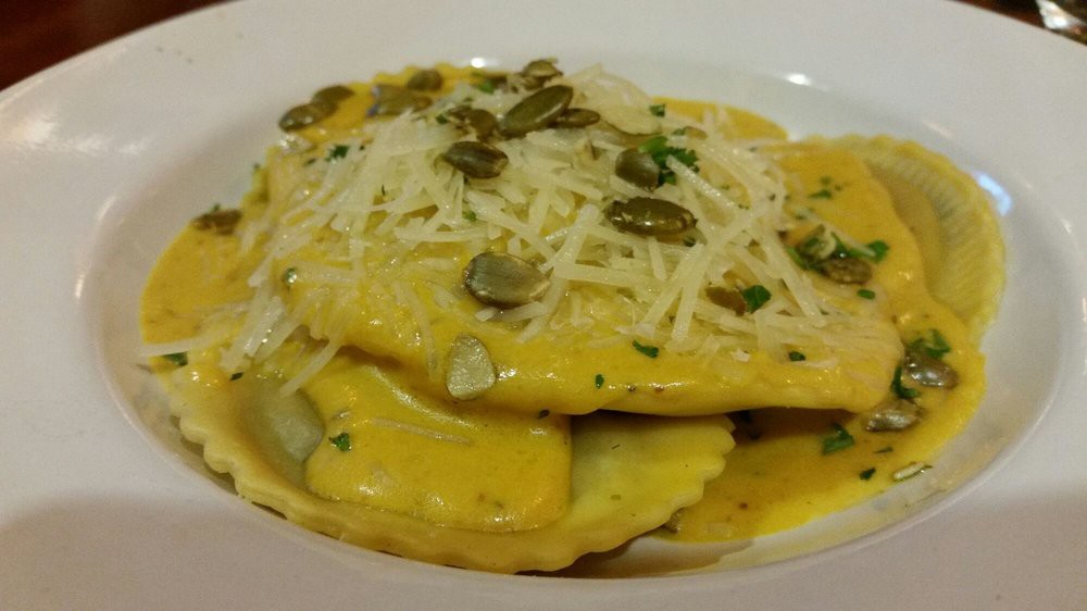 Delicious ravioli topped with grated cheese and pumpkin seeds.