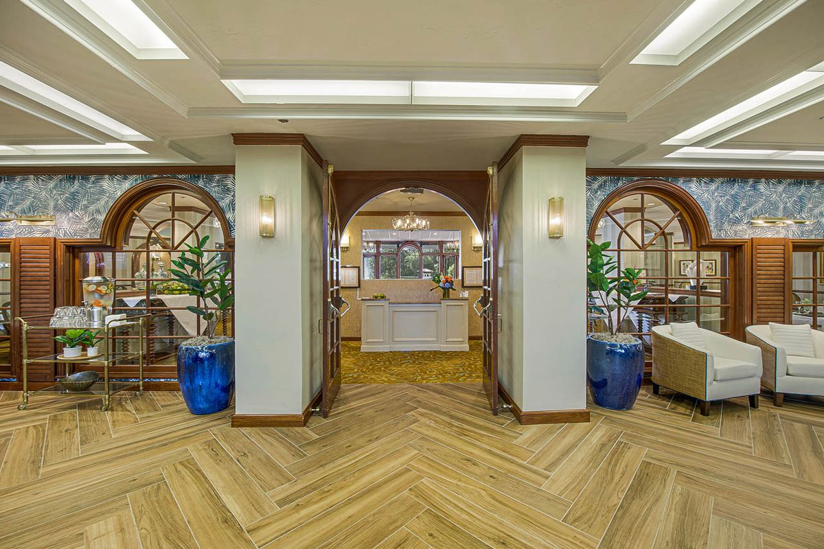 A modern lobby entrance with stylish flooring and decorative plants.