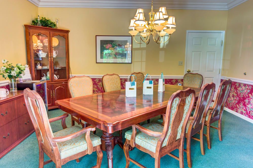 A well-furnished dining room with elegant chairs and a chandelier.