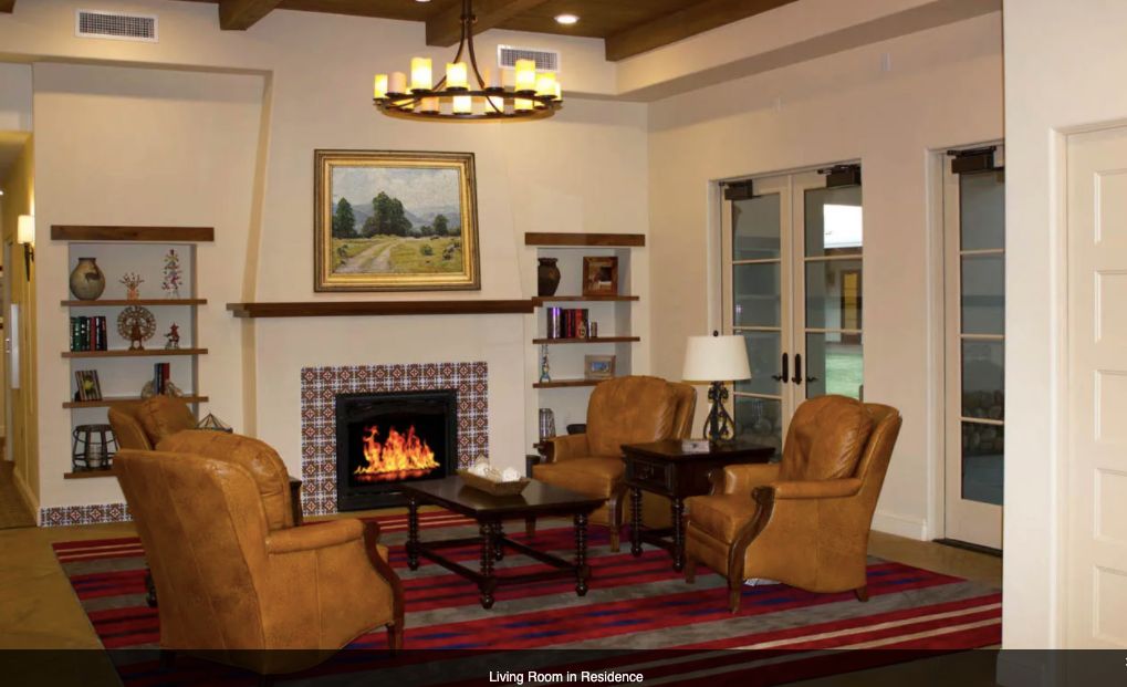 A cozy living room with a fireplace, comfortable seating, and stylish decor.