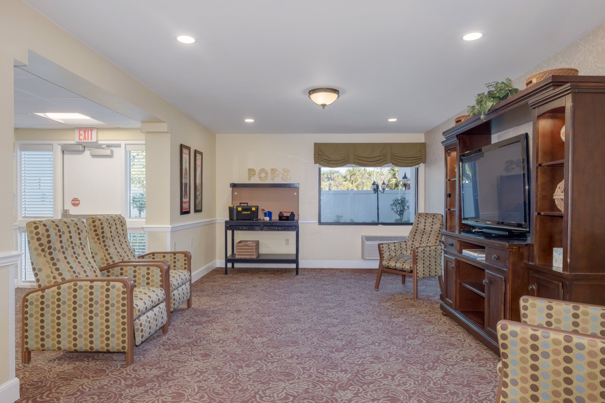 A cozy living room with comfortable seating and a large TV.