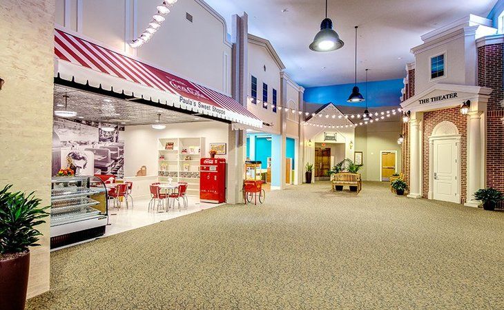 A vintage-style indoor space with retro decor and string lights, featuring a small shop setup.