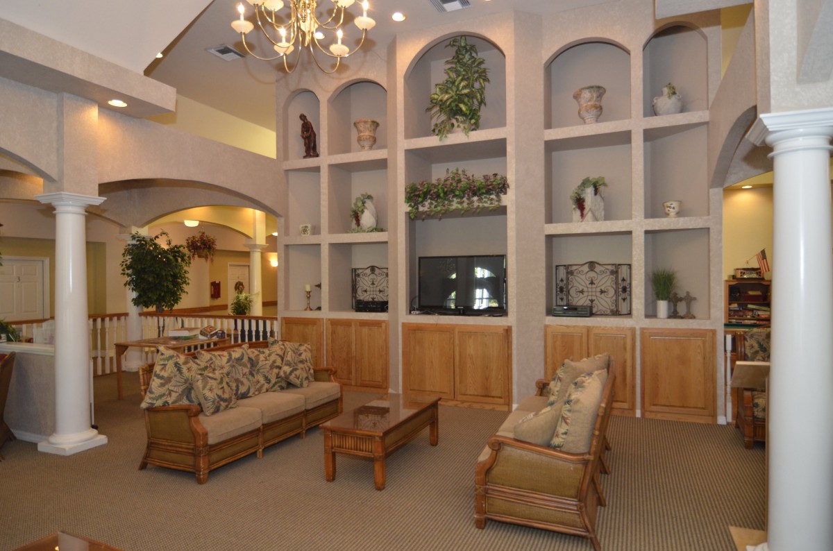 A cozy living room featuring elegant furniture and decorative shelving.
