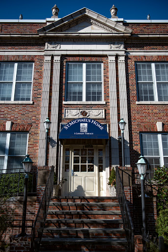 The elegant entrance of a historic brick building, showcasing classic architectural features.