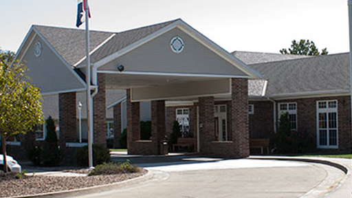 The welcoming entrance to a modern facility, complete with a flagpole and accessible design.