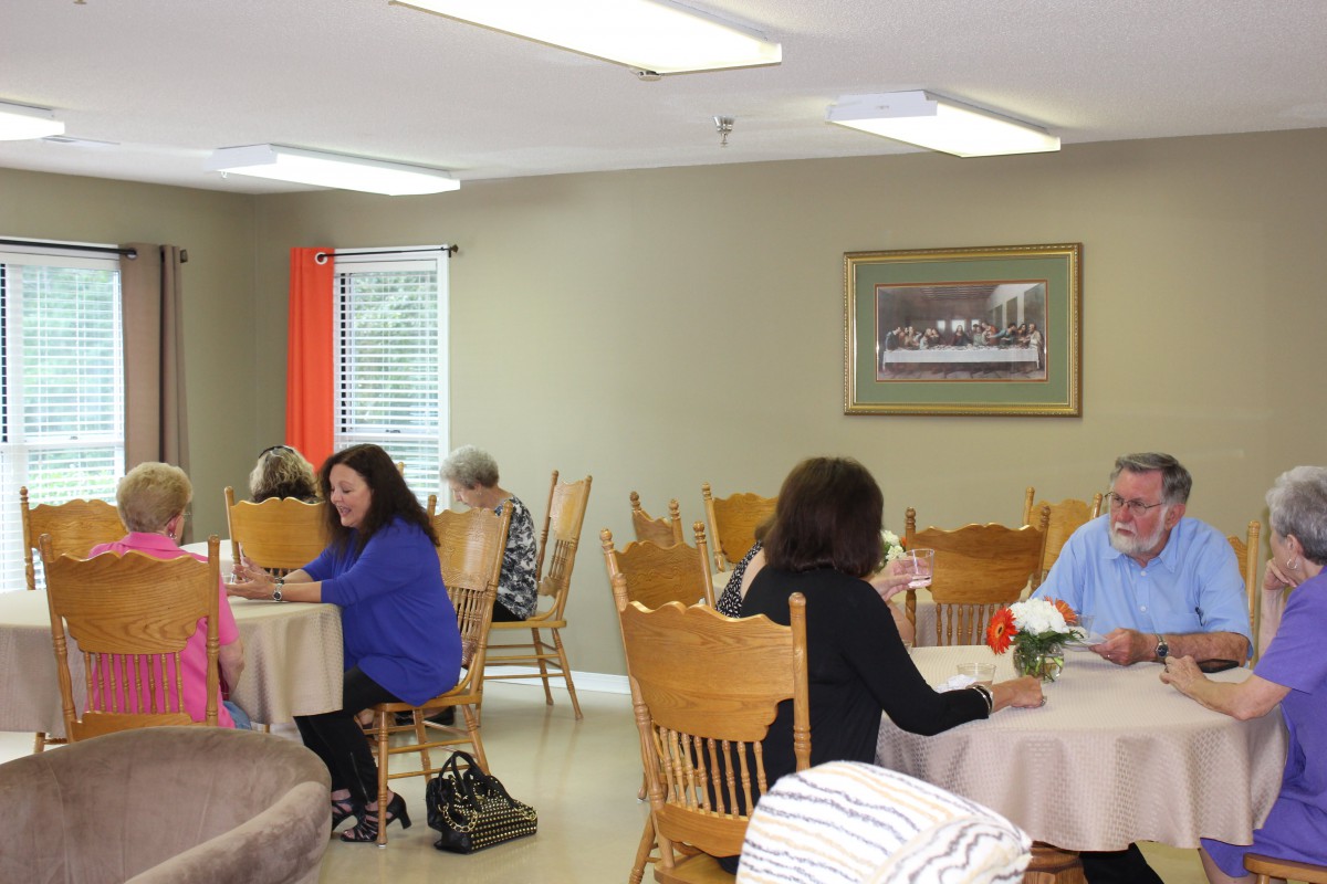 People dining and socializing in a restaurant or cafeteria setting.