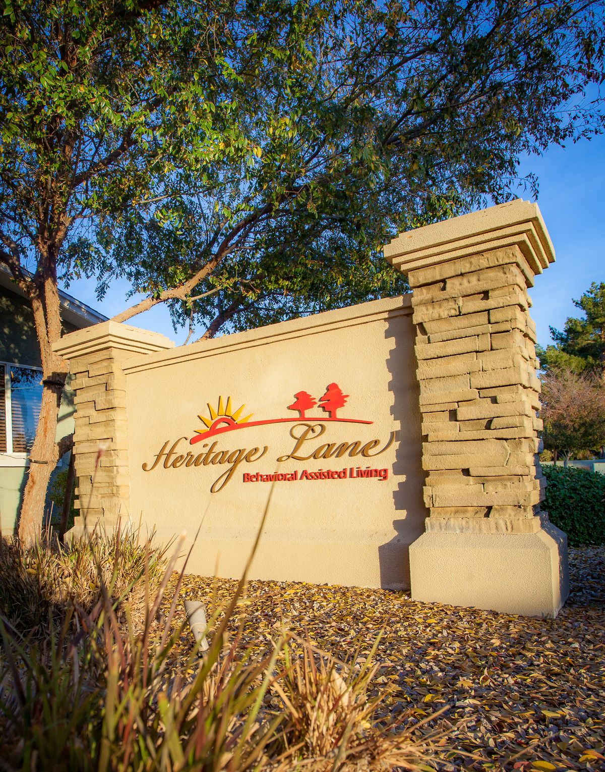 A decorative entrance sign for Heritage Lane, an independent senior living community.