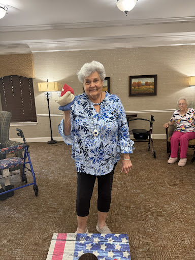 A joyful moment captured at a senior living community, showcasing laughter and engagement.