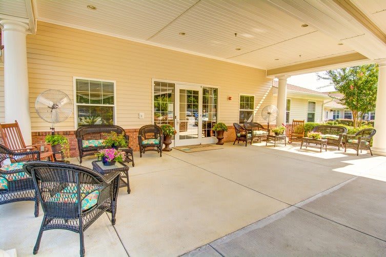 A spacious outdoor patio with comfortable seating and decorative flower pots.