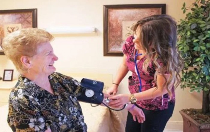 A nurse checks a patient's blood pressure during a medical visit.