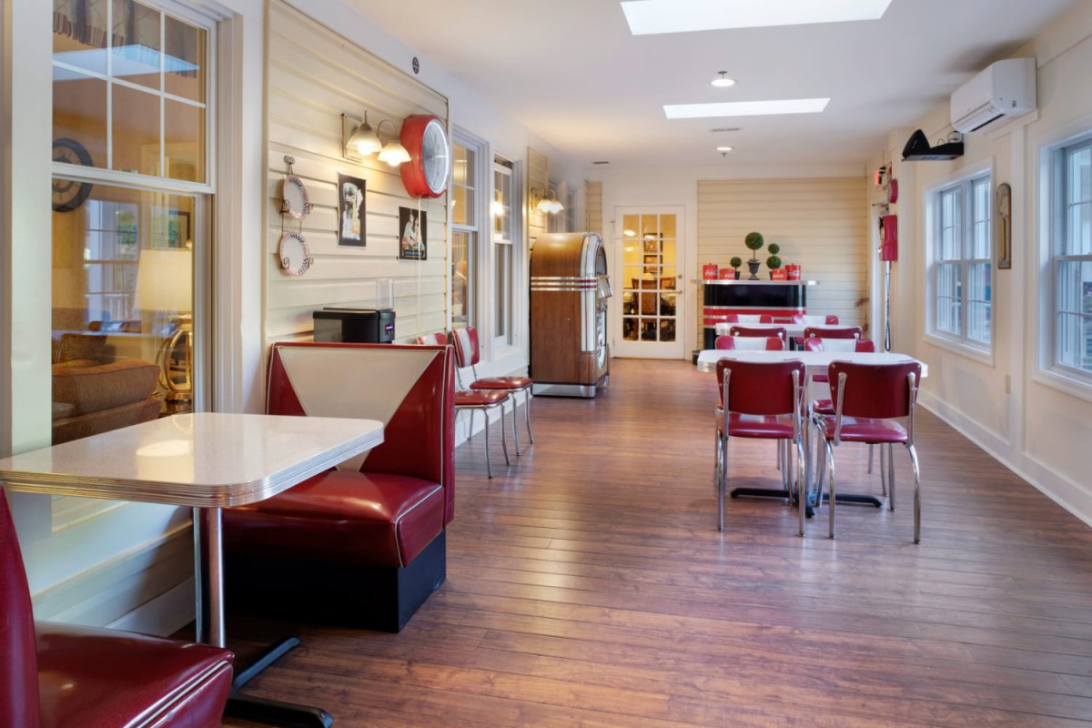 A retro-style diner interior with booths and tables set up for dining.