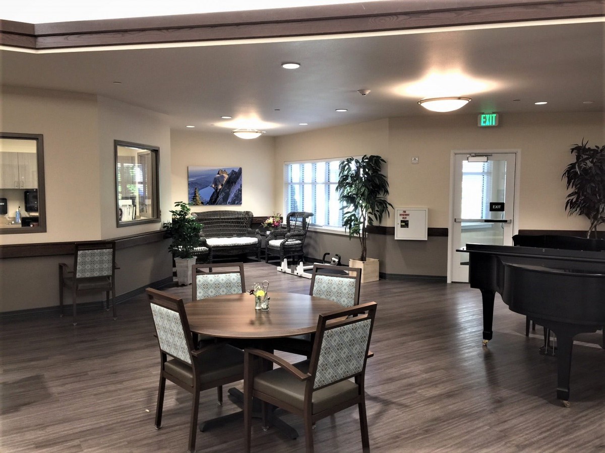 A well-lit dining area with tables and chairs arranged neatly.