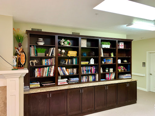 A well-organized bookshelf showcasing a variety of books and decorative items.
