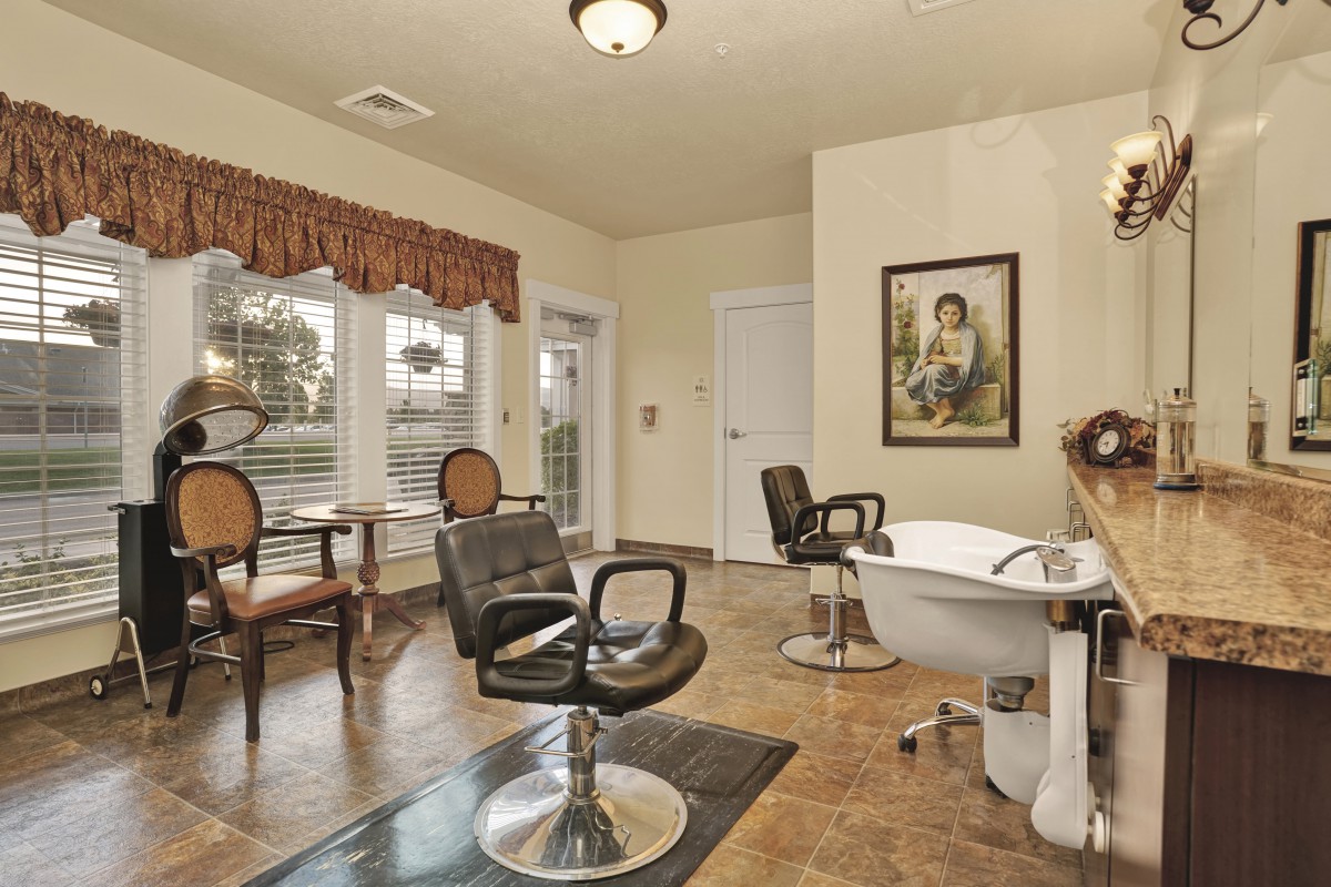 A cozy salon interior with styling chairs, a washing station, and elegant decor.