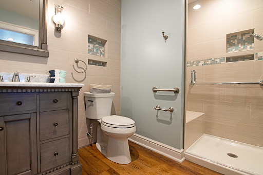 A stylish and modern bathroom featuring a clean design with a shower, toilet, and a wooden vanity.