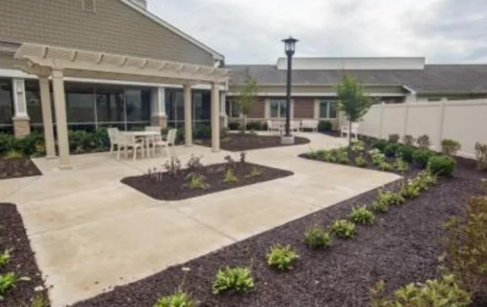 A landscaped courtyard with outdoor seating and walkways between buildings.